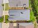 A bird's eye view of a home with a well-maintained gray roof, green lawn and manicured landscaping at 307 Serenity Way, Woodstock, GA 30188
