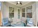 Comfortable covered porch with seating, a ceiling fan, and view of the private backyard at 307 Serenity Way, Woodstock, GA 30188