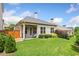 Backyard patio with seating area, overlooking a large, grassy lawn and privacy landscaping at 307 Serenity Way, Woodstock, GA 30188