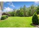Spacious backyard with lush green lawn, mature trees, and well-maintained landscaping at 307 Serenity Way, Woodstock, GA 30188