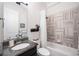 Elegant bathroom featuring granite counters and stylish gray and white tile in the shower at 307 Serenity Way, Woodstock, GA 30188