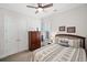 Cozy bedroom with a bed, an armoire, and a window, and a double door closet at 307 Serenity Way, Woodstock, GA 30188
