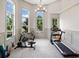 Bright exercise room featuring large windows, wainscoting, and a variety of fitness equipment at 307 Serenity Way, Woodstock, GA 30188