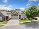 Charming home featuring a stone facade, two-car garage, and well-manicured front yard at 307 Serenity Way, Woodstock, GA 30188