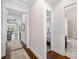 Bright hallway with hardwood floors leads to the living area and bathroom at 307 Serenity Way, Woodstock, GA 30188