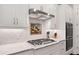 Modern kitchen featuring white cabinets, stainless steel appliances, and a gas cooktop at 307 Serenity Way, Woodstock, GA 30188