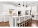 Modern kitchen features white cabinets, stainless steel appliances, granite countertops, and a large island at 307 Serenity Way, Woodstock, GA 30188
