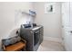Modern laundry room with front loading washer and dryer, and upper wall shelves at 307 Serenity Way, Woodstock, GA 30188