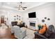 Comfortable living room with a fireplace, TV, and leather furniture at 307 Serenity Way, Woodstock, GA 30188