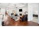 Open living area featuring a fireplace, comfortable seating, and hardwood floors at 307 Serenity Way, Woodstock, GA 30188