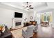 Bright living room with fireplace, TV, and comfortable leather seating at 307 Serenity Way, Woodstock, GA 30188
