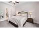 Comfortable main bedroom with a queen-size bed, ceiling fan, bedside tables, and a view to the bathroom at 307 Serenity Way, Woodstock, GA 30188