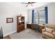 Cozy office space with a ceiling fan, a large window, and built-in wooden shelving at 307 Serenity Way, Woodstock, GA 30188