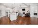 Open floor plan featuring the kitchen, a living room, hardwood floors, and modern decor at 307 Serenity Way, Woodstock, GA 30188