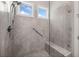 Modern tiled shower with a glass door, two shower heads, a built-in bench, and a grab bar at 307 Serenity Way, Woodstock, GA 30188