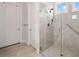 Modern tiled shower with a glass door and shower head, grab bar, and tile floor at 307 Serenity Way, Woodstock, GA 30188
