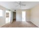 Neutral bedroom featuring a ceiling fan and doorways leading to an ensuite bathroom at 346 Carpenter Dr # 70, Atlanta, GA 30328