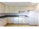 Bright, updated kitchen with white appliances and cabinetry at 346 Carpenter Dr # 70, Atlanta, GA 30328