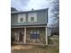 Two-story townhouse featuring stone accents, green siding, shuttered windows, and a welcoming front door at 3500 Ten Oaks Ct, Powder Springs, GA 30127