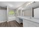 Bright bathroom featuring double sinks, a large mirror, separate shower, and a tub under a window at 470 Piney Sw Way, Atlanta, GA 30331