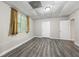 Bedroom with modern flooring, natural light from window, and doors to other rooms at 470 Piney Sw Way, Atlanta, GA 30331