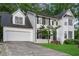 Charming two-story white home with black shutters, manicured lawn, and a two-car garage at 470 Piney Sw Way, Atlanta, GA 30331