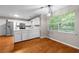 Bright kitchen with stainless steel appliances, white cabinets, and wood floors at 470 Piney Sw Way, Atlanta, GA 30331