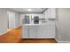 Open-concept kitchen with white cabinets, stainless steel appliances, and breakfast bar at 470 Piney Sw Way, Atlanta, GA 30331