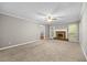 Carpeted living room features a brick fireplace and large windows overlooking the backyard at 470 Piney Sw Way, Atlanta, GA 30331