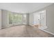 Cozy carpeted living room featuring a large bay window for natural light at 470 Piney Sw Way, Atlanta, GA 30331