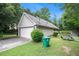 Exterior view of the home showcasing a garage and well-kept yard at 4732 Browns Mill Ferry Rd, Lithonia, GA 30038