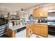 Compact kitchen equipped with modern appliances and ample cabinet space at 4732 Browns Mill Ferry Rd, Lithonia, GA 30038