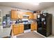 Functional kitchen with oak cabinets, granite-style counters, and modern appliances at 4732 Browns Mill Ferry Rd, Lithonia, GA 30038