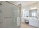 Bright bathroom features dual sink vanity, white cabinets, and walk-in shower at 502 Helene Ct, Woodstock, GA 30188