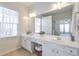 Bathroom features dual sink vanity, white cabinets and a window at 502 Helene Ct, Woodstock, GA 30188