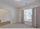 Cozy bedroom featuring neutral carpet, large window, and access to the rest of the house at 502 Helene Ct, Woodstock, GA 30188