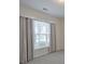 Bright bedroom with soft carpet, large window, and neutral-colored curtains at 502 Helene Ct, Woodstock, GA 30188