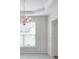 Elegant dining room with decorative chandelier, wainscoting, and large windows for natural light at 502 Helene Ct, Woodstock, GA 30188