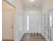 Bright entryway featuring hardwood floors, wainscoting, and a view into other rooms at 502 Helene Ct, Woodstock, GA 30188