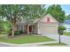 Charming single Gathering home with a well-manicured lawn, two-car garage, and a welcoming front porch at 502 Helene Ct, Woodstock, GA 30188