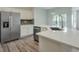 Bright kitchen featuring stainless steel appliances, quartz countertops, and modern backsplash at 502 Helene Ct, Woodstock, GA 30188