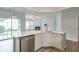 Modern kitchen featuring an island with a sink, stainless steel appliances, and a view to the backyard at 502 Helene Ct, Woodstock, GA 30188