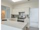 Well-lit kitchen with stainless appliances, white cabinetry, tile backsplash and sink at 502 Helene Ct, Woodstock, GA 30188