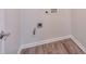 Laundry room features wood look flooring and washer/dryer hookups at 502 Helene Ct, Woodstock, GA 30188
