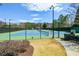 Enjoy a community tennis court with green and blue courts and mature landscaping for the perfect match at 502 Helene Ct, Woodstock, GA 30188