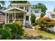 Landscaped backyard with patio, screened-in porch, and mature trees in a suburban setting at 522 Trabert Nw Ave, Atlanta, GA 30309