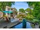 Beautiful backyard with lush landscaping, a water feature, and an outdoor living area at 522 Trabert Nw Ave, Atlanta, GA 30309