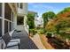 Charming brick patio with lush landscaping, bench seating, and access to a screened-in porch at 522 Trabert Nw Ave, Atlanta, GA 30309