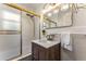 Updated bathroom featuring a vanity, modern mirror with vanity lighting, and tiled shower and walls at 522 Trabert Nw Ave, Atlanta, GA 30309