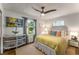 Cozy bedroom with hardwood floors, stylish furniture, natural light, and three-blade ceiling fan at 522 Trabert Nw Ave, Atlanta, GA 30309